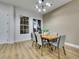 Dining room featuring luxury vinyl plank flooring, neutral paint, modern lighting, and large window at 2873 Knoxville Ct, Henderson, NV 89052