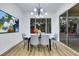 Light and airy dining area featuring modern light fixture and sliding glass door to the outside at 2873 Knoxville Ct, Henderson, NV 89052