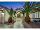 Charming home exterior featuring lush palm trees, desert landscaping, and a gated entrance at 2873 Knoxville Ct, Henderson, NV 89052
