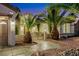 Charming home exterior featuring lush palm trees, desert landscaping, and a gated entrance at 2873 Knoxville Ct, Henderson, NV 89052