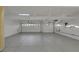 A spacious three-car garage featuring coated flooring and overhead storage racks at 2873 Knoxville Ct, Henderson, NV 89052