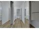Hallway features dual mirrored sliding closet doors and wood floors at 2873 Knoxville Ct, Henderson, NV 89052