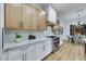 White and light wood kitchen with stainless appliances and view to dining room at 2873 Knoxville Ct, Henderson, NV 89052