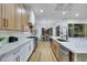 A bright, modern kitchen with white marble counters, stainless steel appliances, and wood cabinets at 2873 Knoxville Ct, Henderson, NV 89052