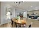 Open-concept living and dining area boasts a modern light fixture and neutral color palette at 2873 Knoxville Ct, Henderson, NV 89052