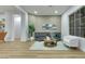 Bright living room featuring luxury vinyl plank flooring, gray couch, area rug, and plenty of natural light at 2873 Knoxville Ct, Henderson, NV 89052