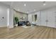 Open concept living room with luxury vinyl plank flooring, neutral colors, and large windows at 2873 Knoxville Ct, Henderson, NV 89052