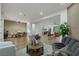 Spacious living room with a gray couch, area rug, open concept kitchen, and dining area at 2873 Knoxville Ct, Henderson, NV 89052