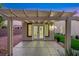 Back patio with white pergola cover and direct access through windows and glass panel door at 2873 Knoxville Ct, Henderson, NV 89052