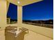 Picturesque balcony with outdoor chairs and views of the city at dusk at 3 Hilltop Crest St, Henderson, NV 89011