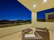 Tranquil balcony with outdoor furniture, showcasing city skyline at night at 3 Hilltop Crest St, Henderson, NV 89011