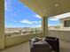 Relaxing balcony with patio furniture and city views at 3 Hilltop Crest St, Henderson, NV 89011