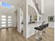Open-concept living space showcasing a modern bar area with a granite countertop and stainless steel bar stools at 3 Hilltop Crest St, Henderson, NV 89011