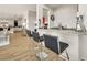 Modern bar area featuring a granite countertop, seating for three, and wood-look tile floors at 3 Hilltop Crest St, Henderson, NV 89011