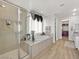 Elegant bathroom with a large soaking tub, shower, and stylish decor at 3 Hilltop Crest St, Henderson, NV 89011