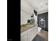 Bathroom with granite counters, white cabinets, and a shower with decorative curtains at 3 Hilltop Crest St, Henderson, NV 89011