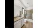 Bathroom featuring granite counters, glass shower, and bright natural light at 3 Hilltop Crest St, Henderson, NV 89011