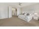 Bright primary bedroom featuring a large bed, neutral carpet, and modern nightstands at 3 Hilltop Crest St, Henderson, NV 89011