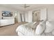 Bright bedroom featuring neutral tones, TV, ceiling fan, and ample closet space at 3 Hilltop Crest St, Henderson, NV 89011