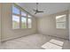 Bright bedroom featuring large windows offering scenic mountain views and neutral color palette at 3 Hilltop Crest St, Henderson, NV 89011