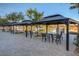 Community lakeside seating area features shaded tables and a serene waterfront view for resident enjoyment at 3 Hilltop Crest St, Henderson, NV 89011