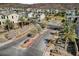 Community entrance with a gate, landscaped with desert plants and palm trees at 3 Hilltop Crest St, Henderson, NV 89011