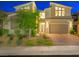 Modern home with a well-maintained lawn, desert landscaping and a large two-car garage at 3 Hilltop Crest St, Henderson, NV 89011