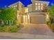 Contemporary home exterior showing a multi-car garage, decorative landscaping and modern architectural details at 3 Hilltop Crest St, Henderson, NV 89011