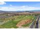 An aerial view of the golf course with the city skyline and desert landscape in the background at 3 Hilltop Crest St, Henderson, NV 89011