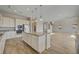 Modern kitchen boasts stainless appliances, granite counters, breakfast bar, and a seamless flow into the living area at 3 Hilltop Crest St, Henderson, NV 89011