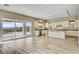 Sunlit kitchen showcases granite counters, stainless appliances, breakfast bar, and seamless transition to outdoor patio at 3 Hilltop Crest St, Henderson, NV 89011