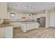 Modern kitchen features granite countertops, stainless steel appliances, breakfast bar, and wood-look tile flooring at 3 Hilltop Crest St, Henderson, NV 89011
