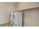 Laundry room with white appliances and wooden-look tile flooring at 3 Hilltop Crest St, Henderson, NV 89011