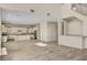 Expansive living area with kitchen, features wood-look tile floors, and natural light, creating an inviting atmosphere at 3 Hilltop Crest St, Henderson, NV 89011