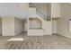 Bright living area featuring wood-look tile flooring and a modern staircase with stainless steel railings at 3 Hilltop Crest St, Henderson, NV 89011