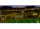 Nighttime view of homes in a neighborhood against a skyline, highlighting community living and city proximity at 3 Hilltop Crest St, Henderson, NV 89011