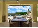 Covered patio with outdoor dining area and a view of the lush backyard and pool at 3 Hilltop Crest St, Henderson, NV 89011