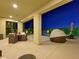 Covered patio with modern furniture and outdoor dining overlooking the pool at 3 Hilltop Crest St, Henderson, NV 89011