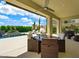 Covered patio featuring an outdoor dining area, barbeque, and a view of the backyard at 3 Hilltop Crest St, Henderson, NV 89011