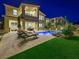 Backyard featuring a private pool, lounge chairs, and covered patio, perfect for outdoor relaxation and entertaining at 3 Hilltop Crest St, Henderson, NV 89011