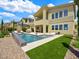 Stunning backyard oasis with a sparkling pool, lounge chairs, and well-maintained landscaping at 3 Hilltop Crest St, Henderson, NV 89011