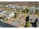 A view of several homes on a street with desert landscaping and mountain views at 3 Hilltop Crest St, Henderson, NV 89011
