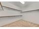 Walk-in closet featuring built-in shelving and neutral carpeting at 3 Hilltop Crest St, Henderson, NV 89011