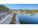 Scenic waterfront view with dining area, docks, and recreational watercraft at 3 Hilltop Crest St, Henderson, NV 89011