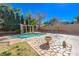Backyard pool with stone landscaping, pergola, and desert plants with a blue sky at 3034 Scenic Valley Way, Henderson, NV 89052