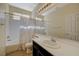 Bathroom features a shower-tub combo and a single sink vanity with dark cabinets and light countertops at 3034 Scenic Valley Way, Henderson, NV 89052