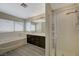 Bathroom features a shower with a glass door and soaking tub with dark cabinets at 3034 Scenic Valley Way, Henderson, NV 89052