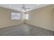Bedroom featuring light gray flooring, a ceiling fan, and two windows for natural light at 3034 Scenic Valley Way, Henderson, NV 89052