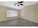 A spacious bedroom with vaulted ceilings, a ceiling fan and light gray wood-look flooring at 3034 Scenic Valley Way, Henderson, NV 89052
