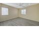 Well lit bedroom with wood look floors and two windows providing natural light at 3034 Scenic Valley Way, Henderson, NV 89052
